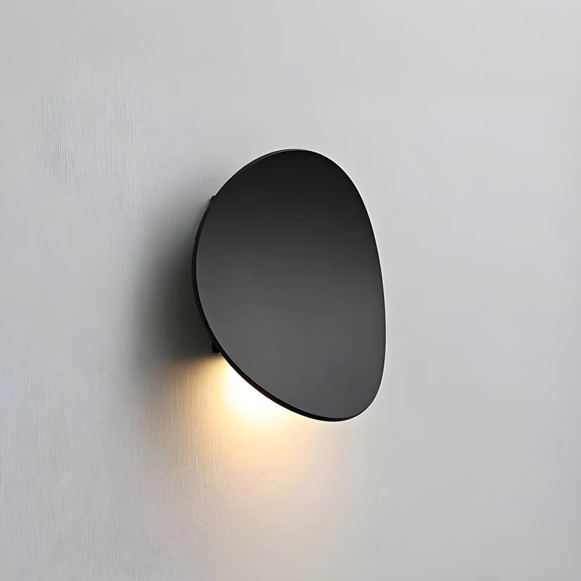 Czarna metalowa lampa łazienkowa na białej ścianie, włączona